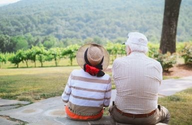 older couple on a bench in nature
