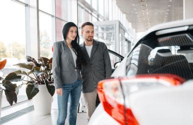 couple in a car showroom